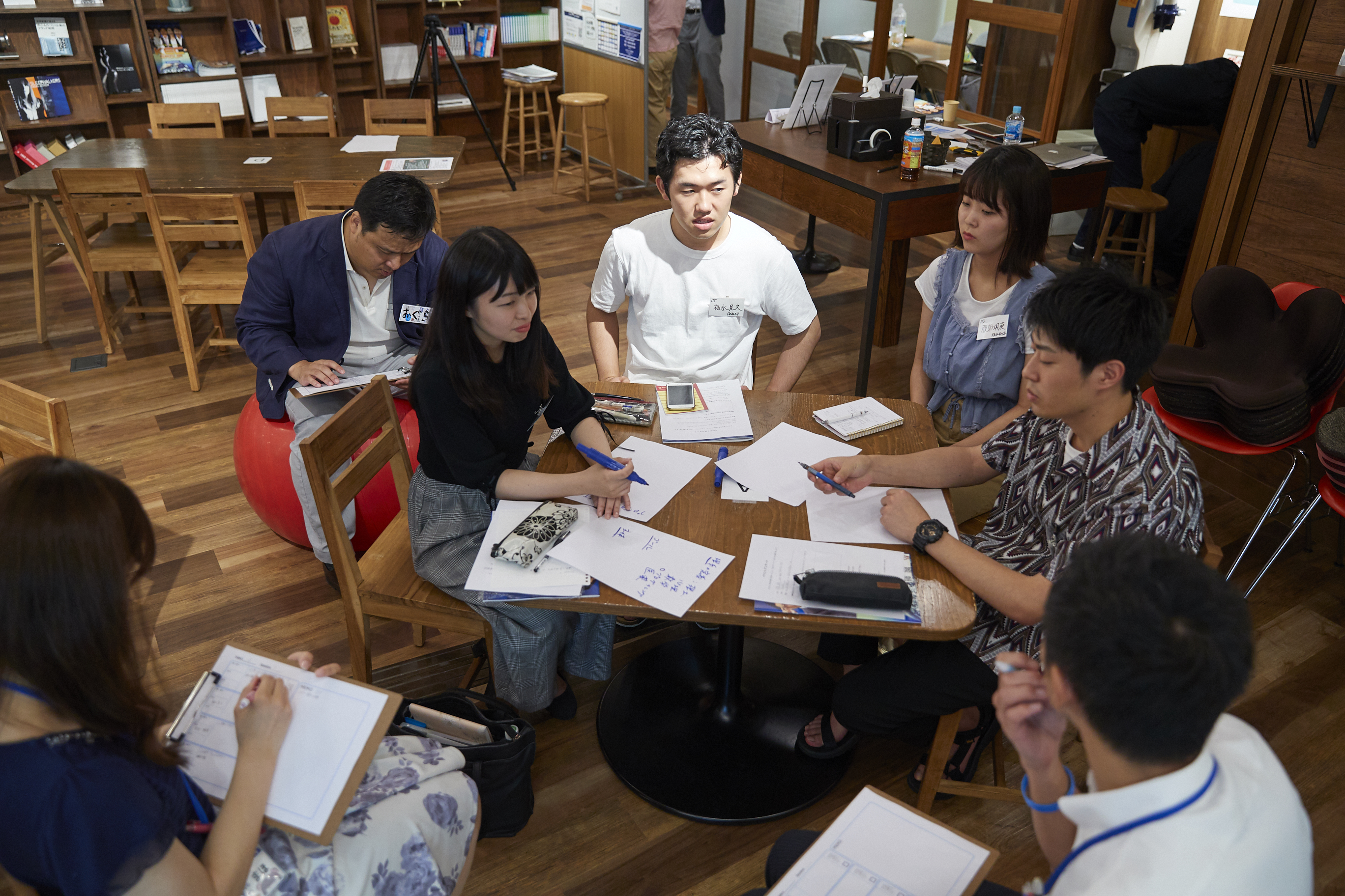 ▲慣れないグループディスカッションに臨む学生の皆さん。企業の人事の方々が見守ります。